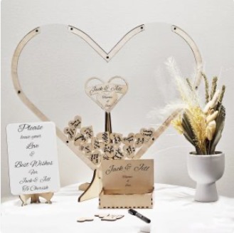 A wooden heart shaped guest book